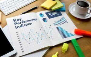 Photo of a desk containing a Key Performance Indicator Report, one of the major digital marketing terms a nonprofit should know.