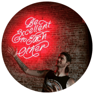 Blaine Slingerland pointing at neon sign