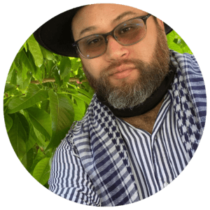 Man wearing hat and glasses outside